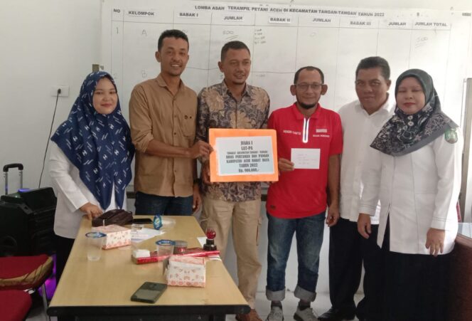 
 Aparatur desa Gampong Suak Nibong Kecamatan Tangan-tangan Kabupaten Aceh Barat Daya, menunjukkan penghargaan Lomba Asah Terampil Petani Aceh tingkat Kecamatan. Foto/Rahmat Gumpalannews.com